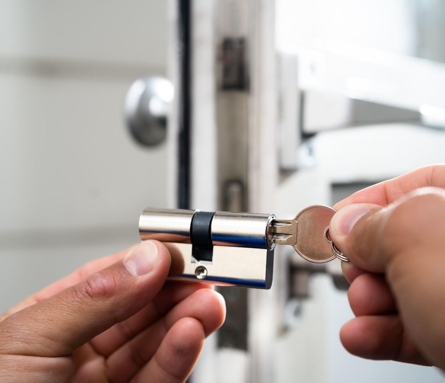 a locksmith checking the door lock with a key