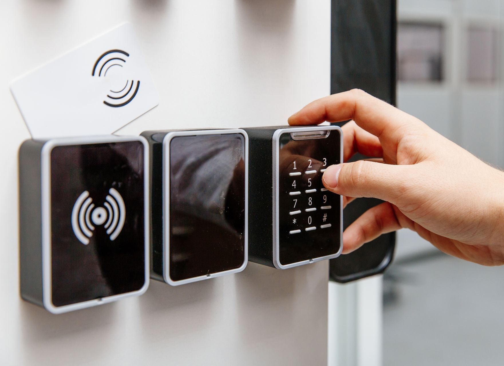 a person is using a remote control to open a door .