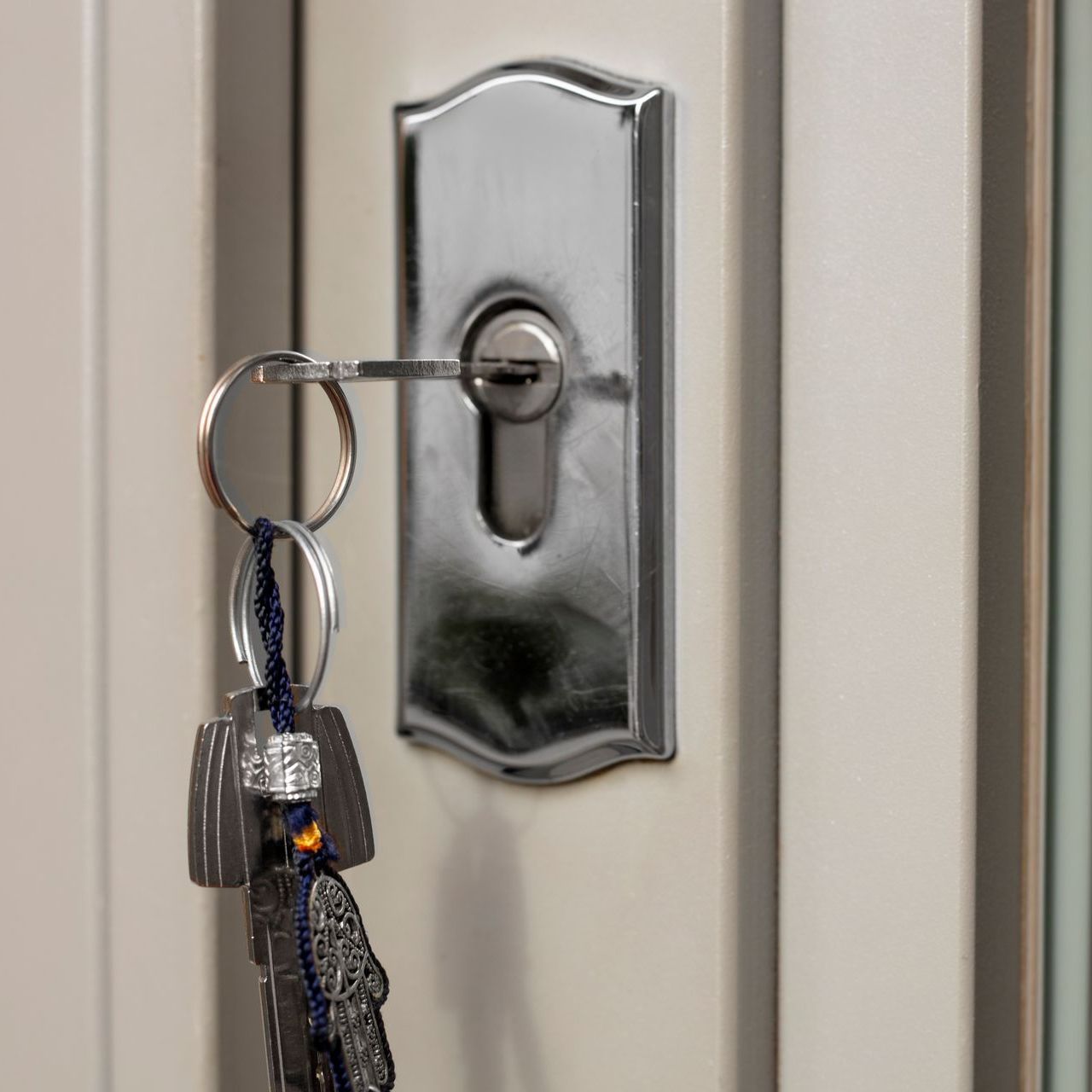 A close up of a door with keys in it.