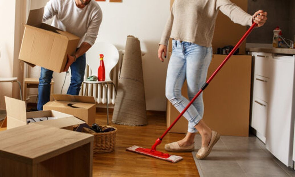 A man wearing a hard hat and goggles is standing in a room.