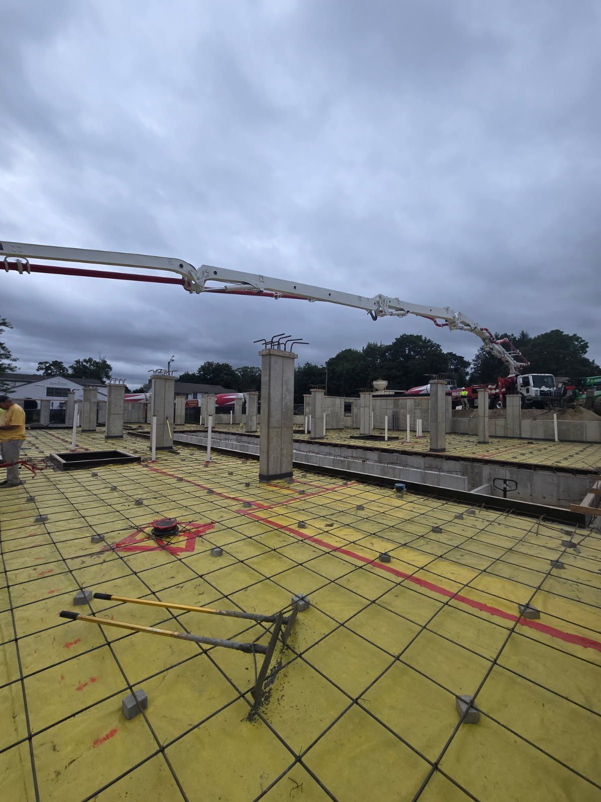 An Aerial View of A Construction Site With A Crane Pouring Concrete - Middletown, CT - American Concrete Pumping