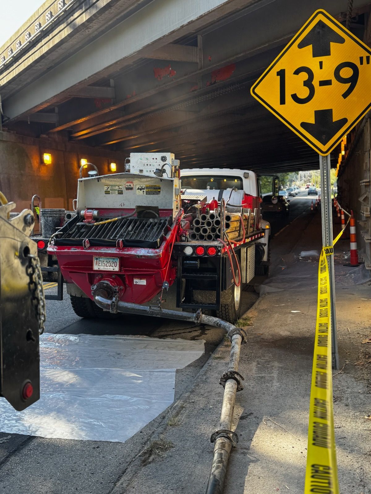 A Man Is Pouring Concrete on A Sidewalk with A Shovel - Middletown, CT - American Concrete Pumping