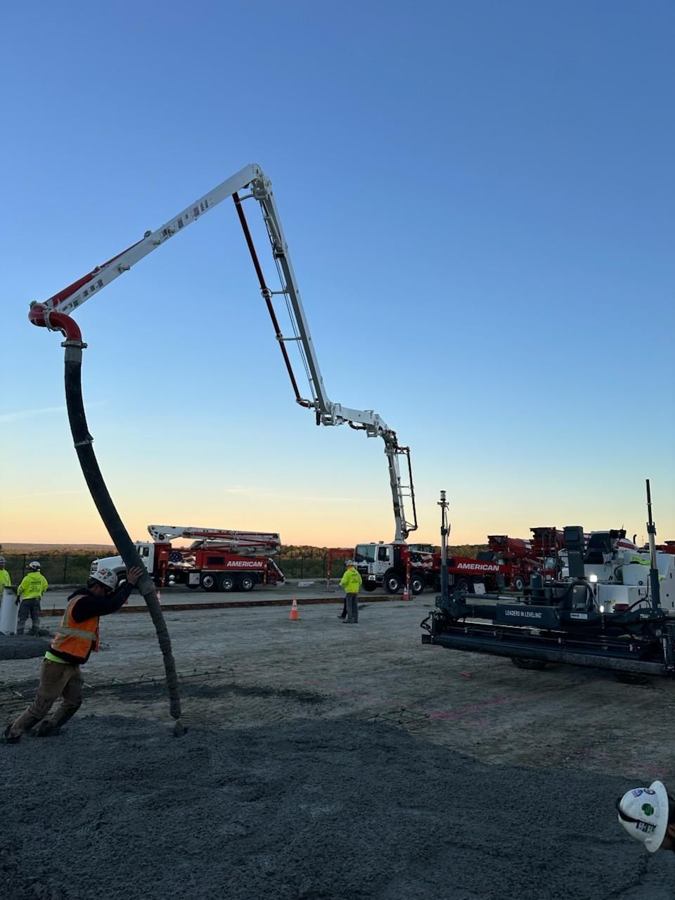A Person Is Pouring Concrete on A Sidewalk in A Yard - Middletown, CT - American Concrete Pumping