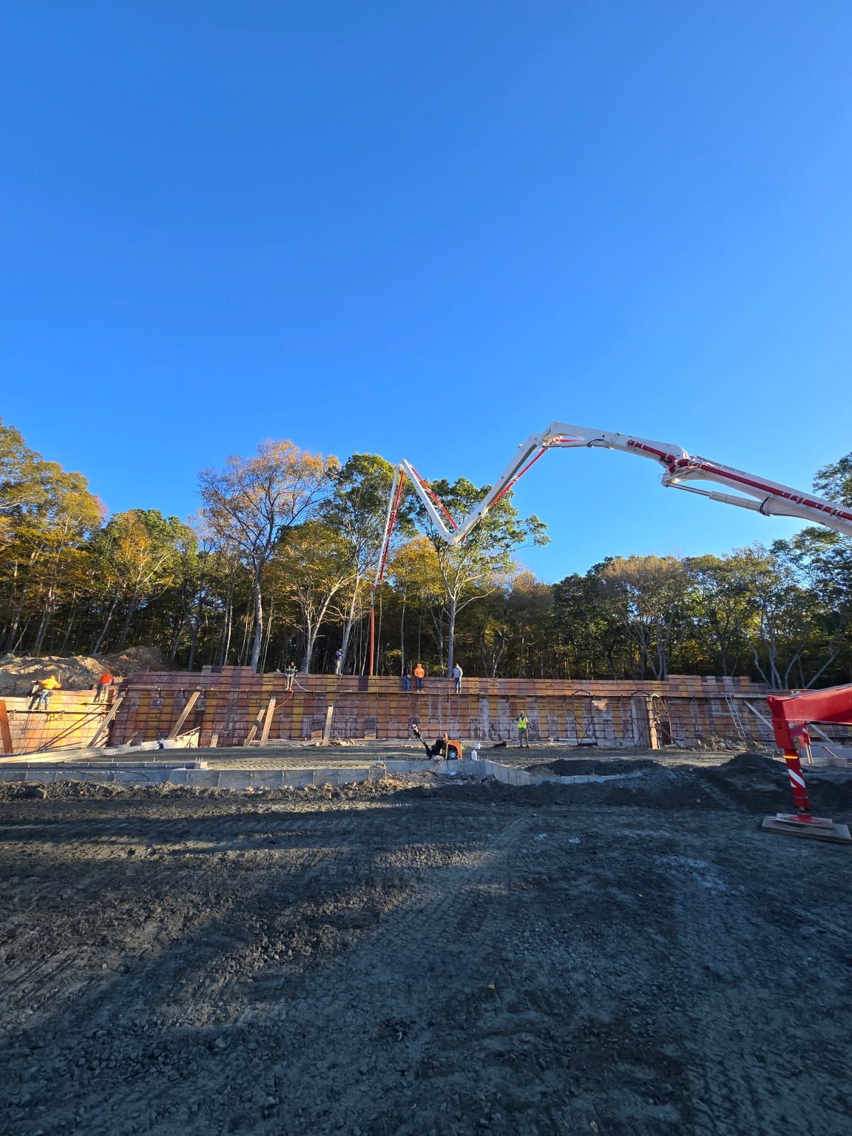 A Hot Tub Is Sitting on A Patio Next to A Waterfall - Middletown, CT - American Concrete Pumping