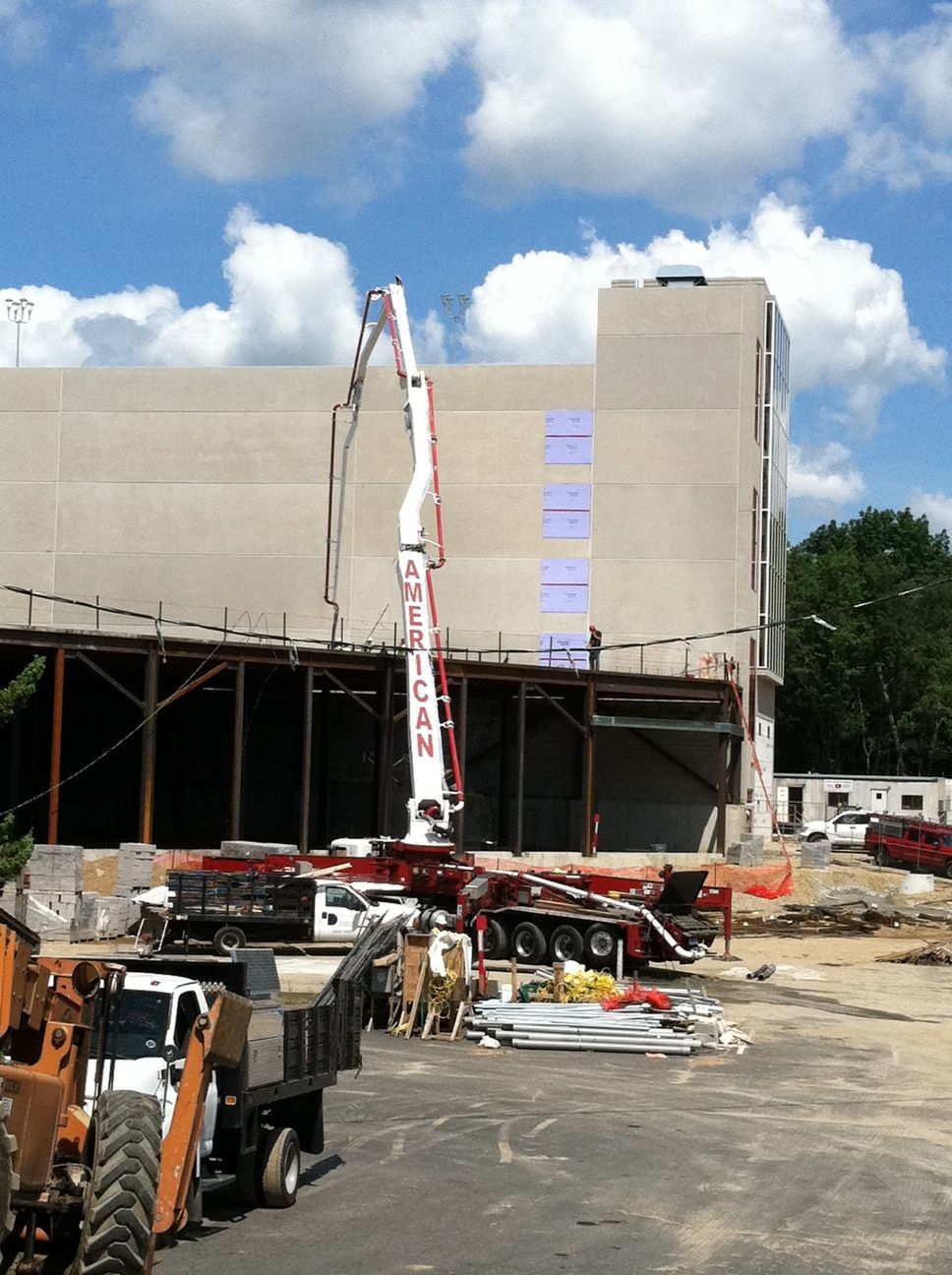 A Construction Site with A Crane Pumping Concrete - Middletown, CT - American Concrete Pumping