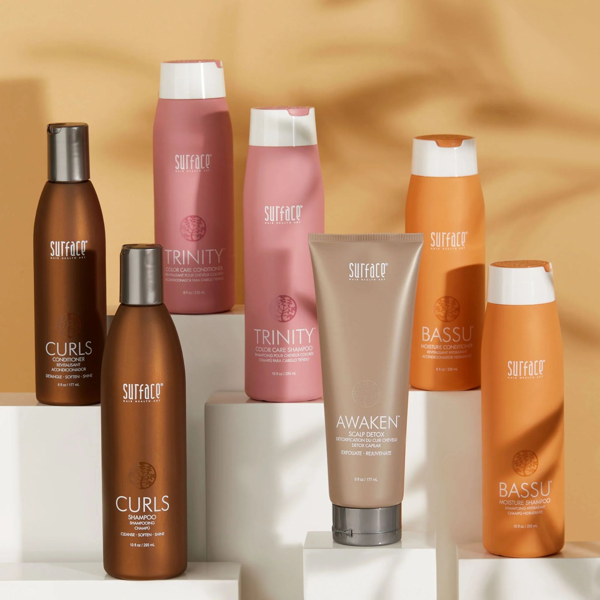 Several bottles of hair products including trinity and curls