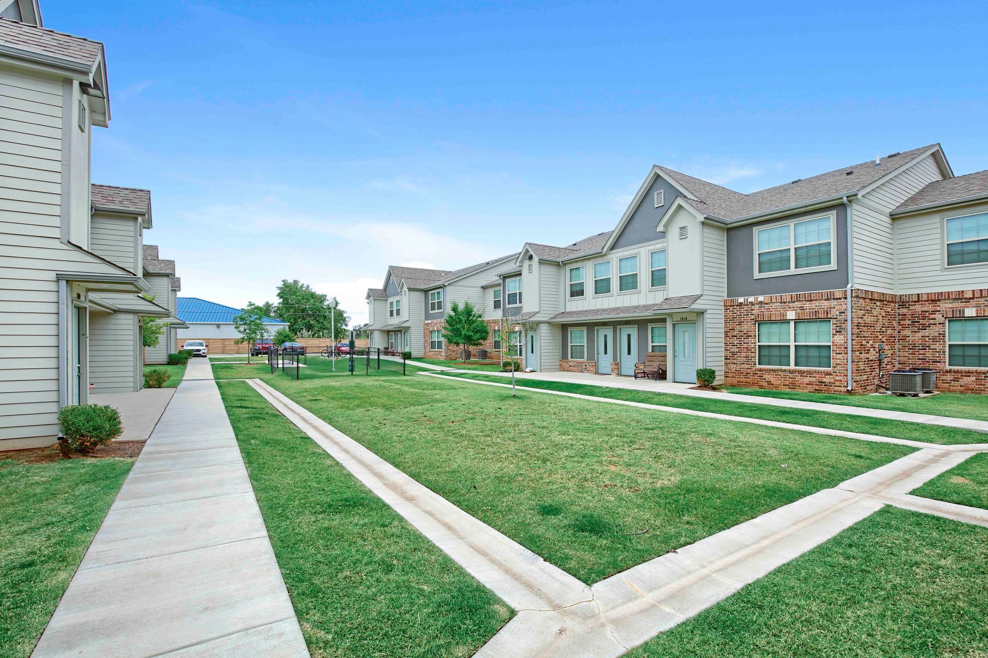 a row of houses with a lawn in front of them