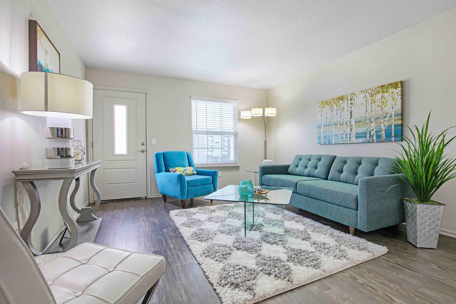 a living room with a blue couch and a blue chair