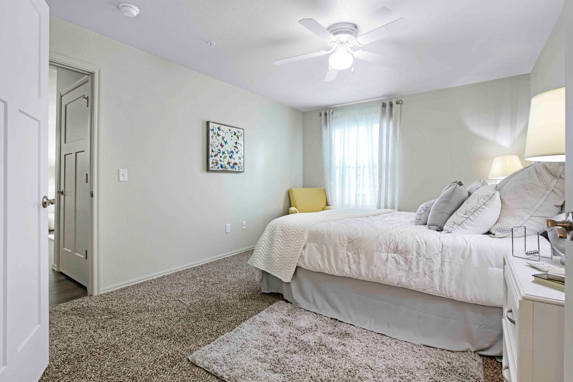 a bedroom with a bed and a ceiling fan