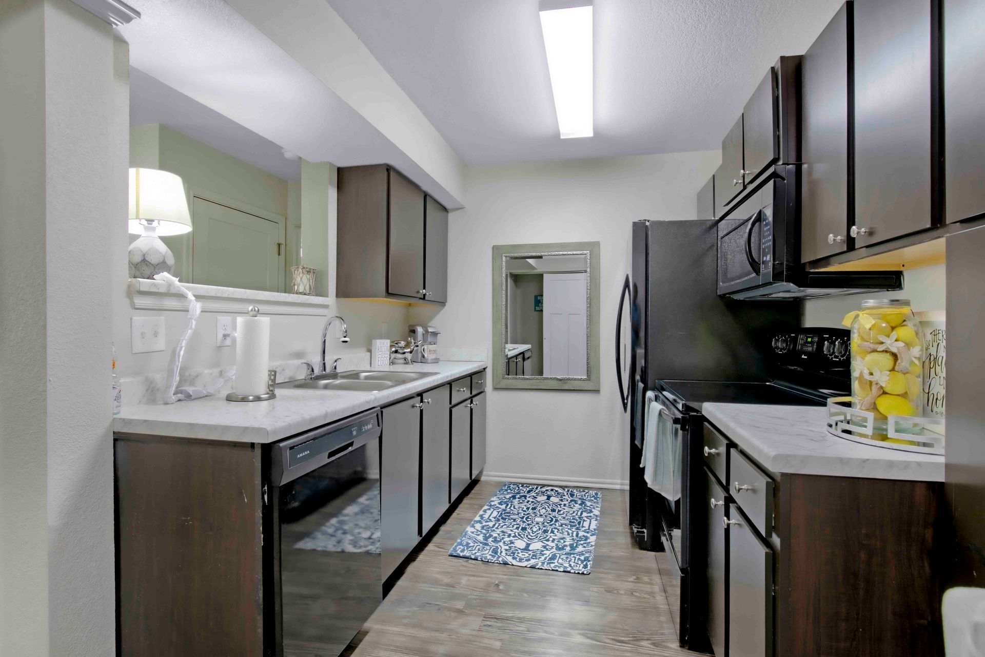 a kitchen with stainless steel appliances and black cabinets