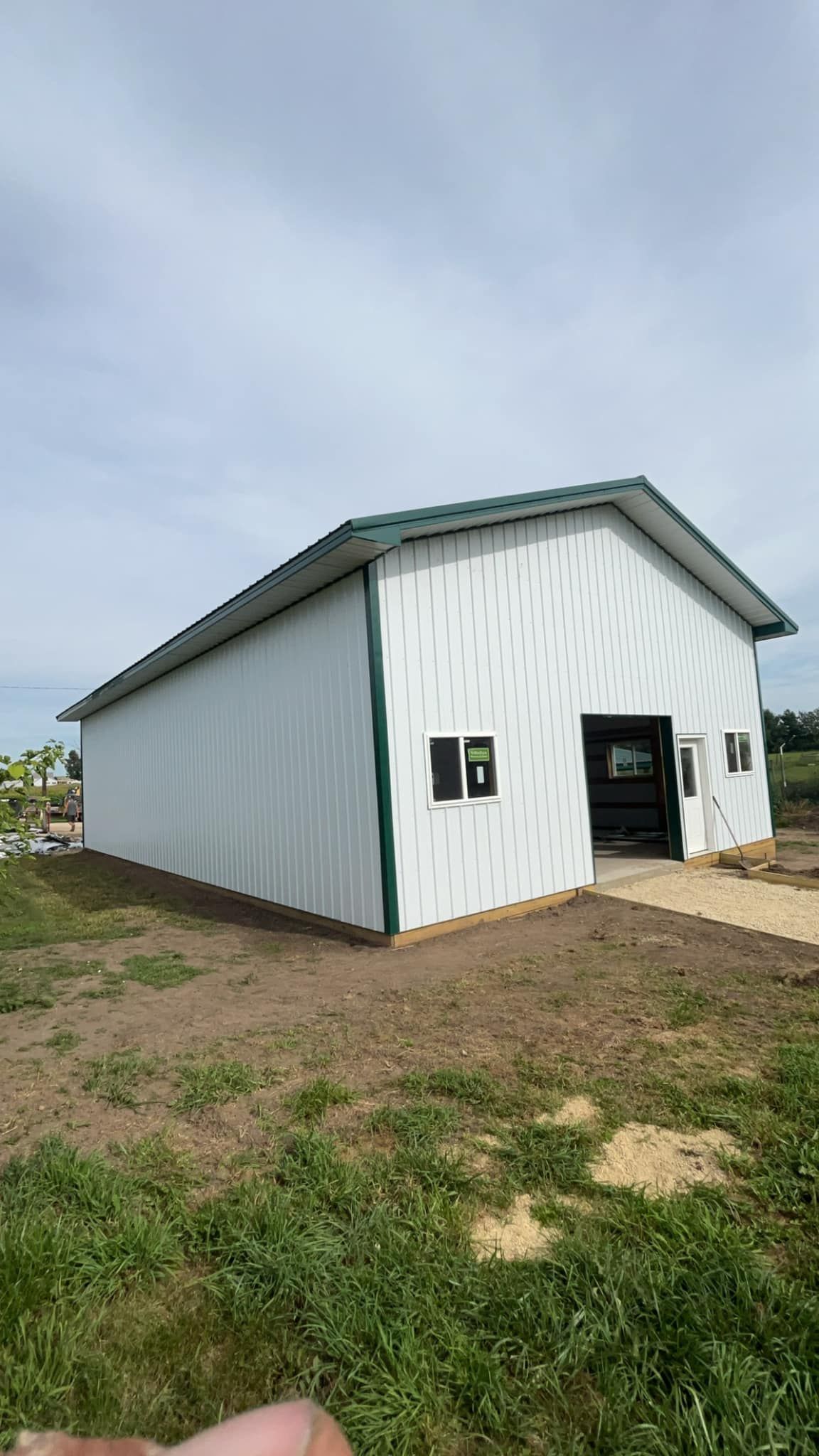 Interior of a large, white-roofed agricultural building.