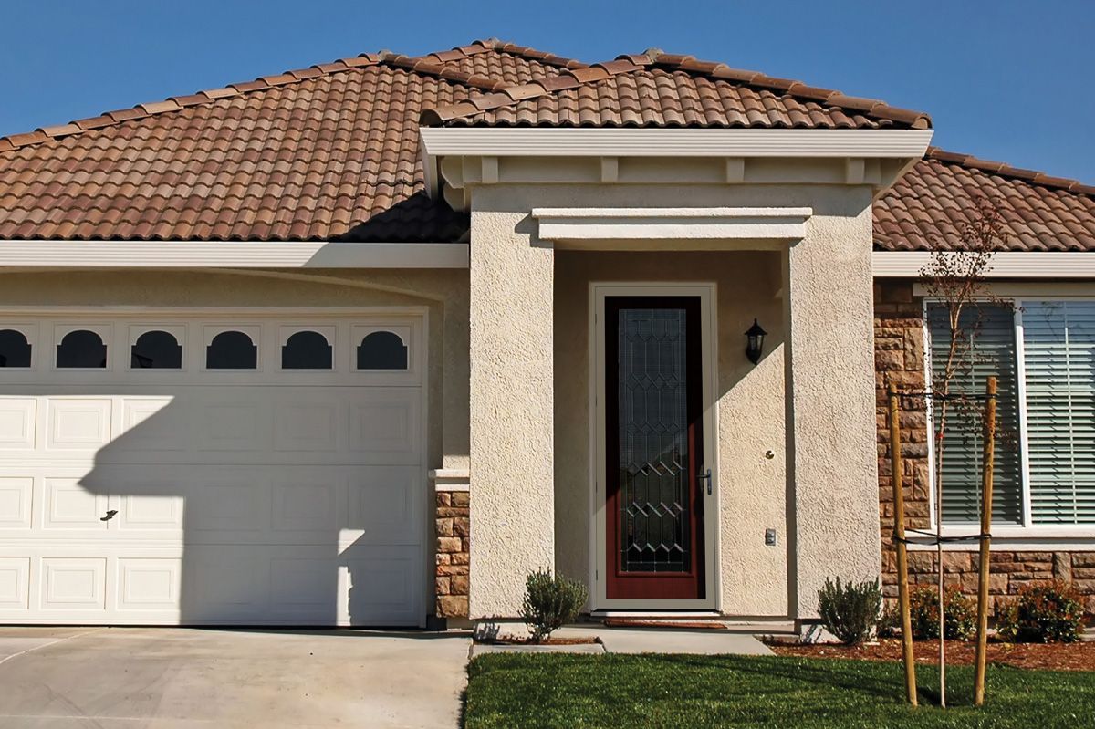 Exterior of a home with a front door fitted with a security screen door