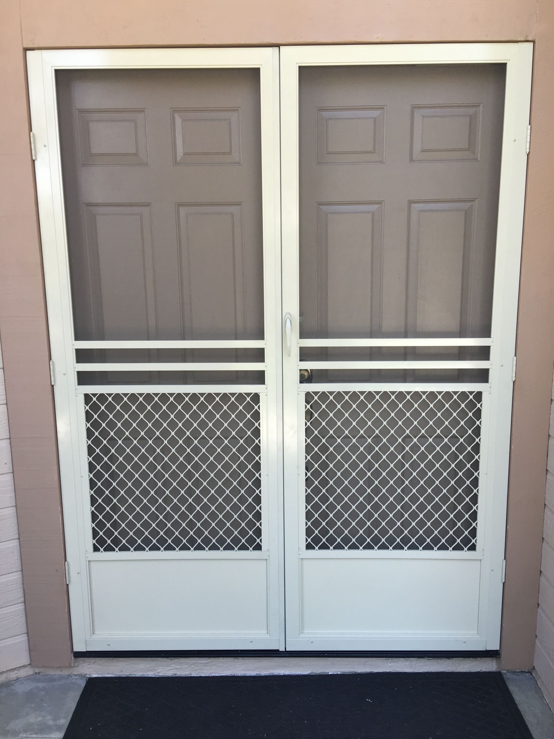 Double doors with white-framed screen panels on the lower half