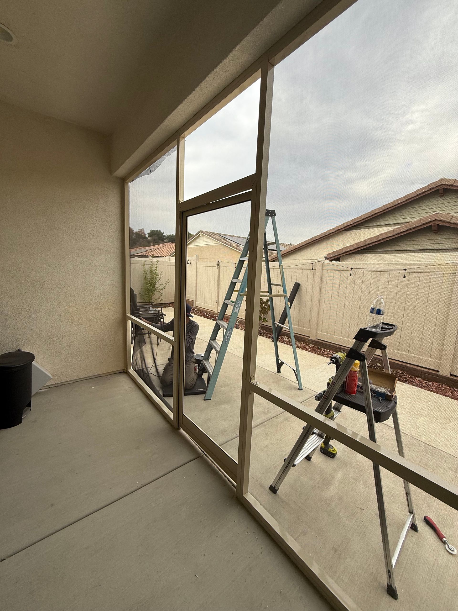 Screened balcony or patio with railing and outdoor workspace setup