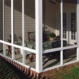 Covered porch with white screen enclosure and seating area