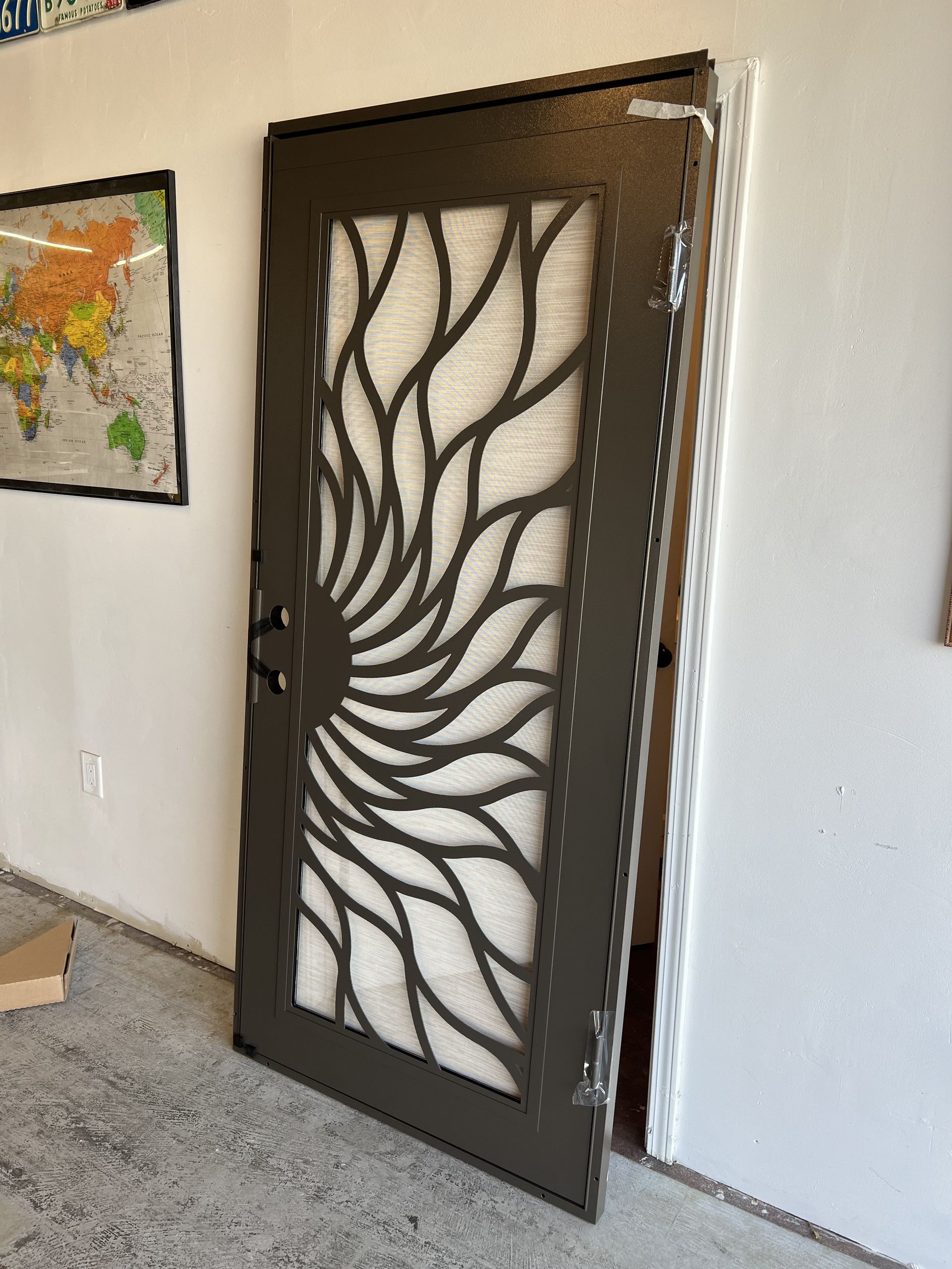 Dark security screen door with modern swirl pattern design