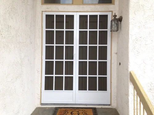 Window with white grid frame and installed screen mesh