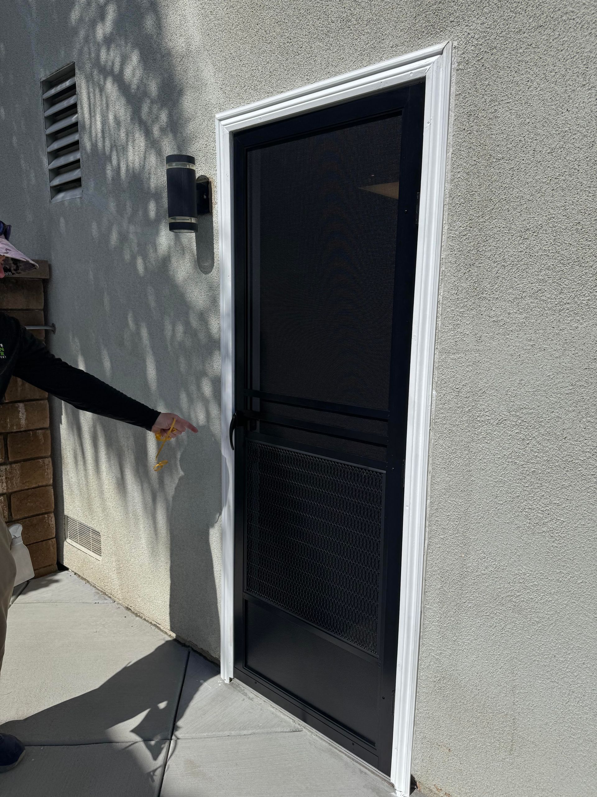 Exterior side door with a dark security screen door installed