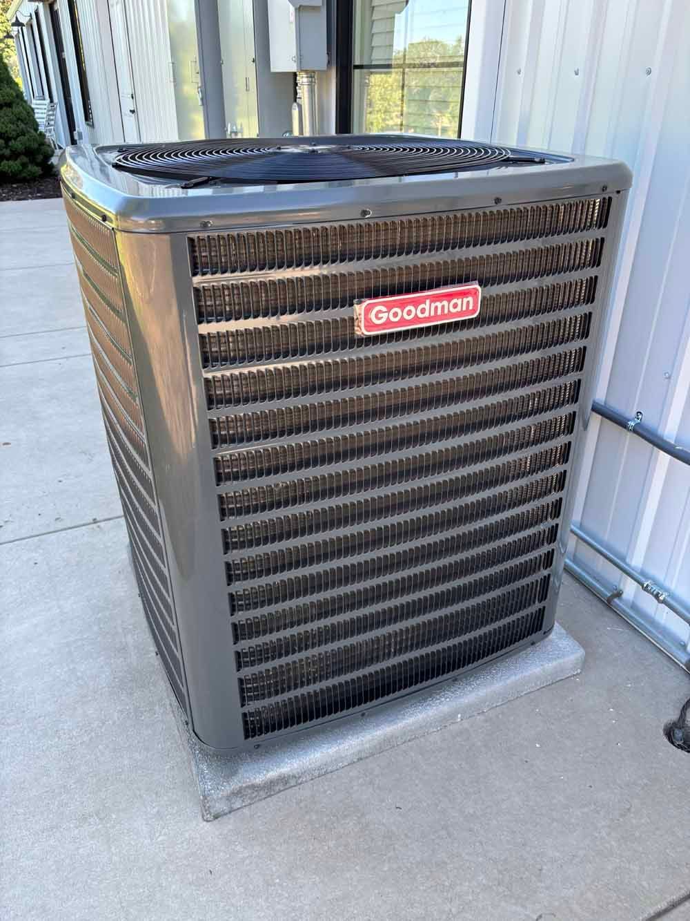 Woman in straw hat smiles, holding wine glass near a lake.