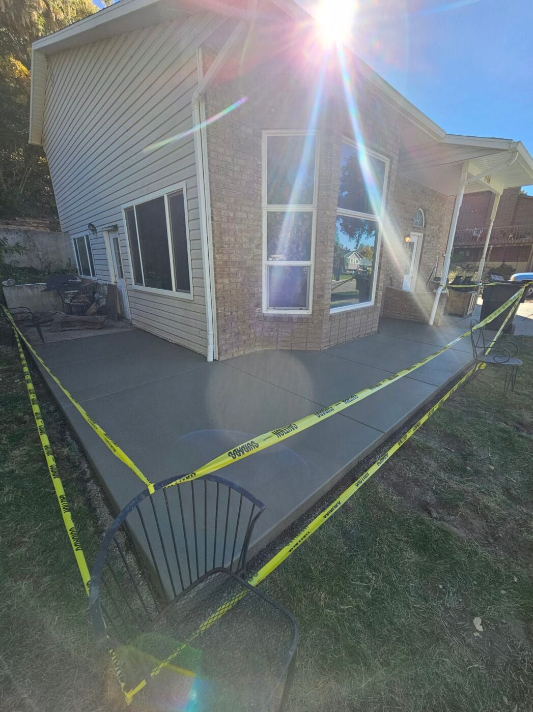 A concrete deck is being built in front of a house.