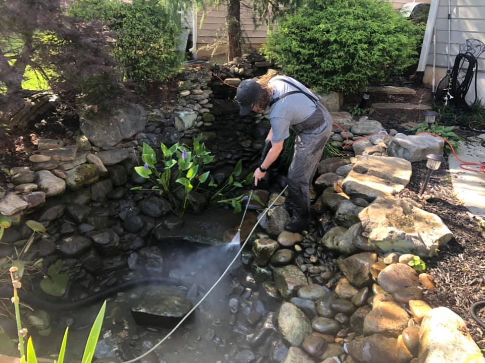 Staff Cleaning Pond with Pressure Washer — Newnan, GA — Aqua Gardens