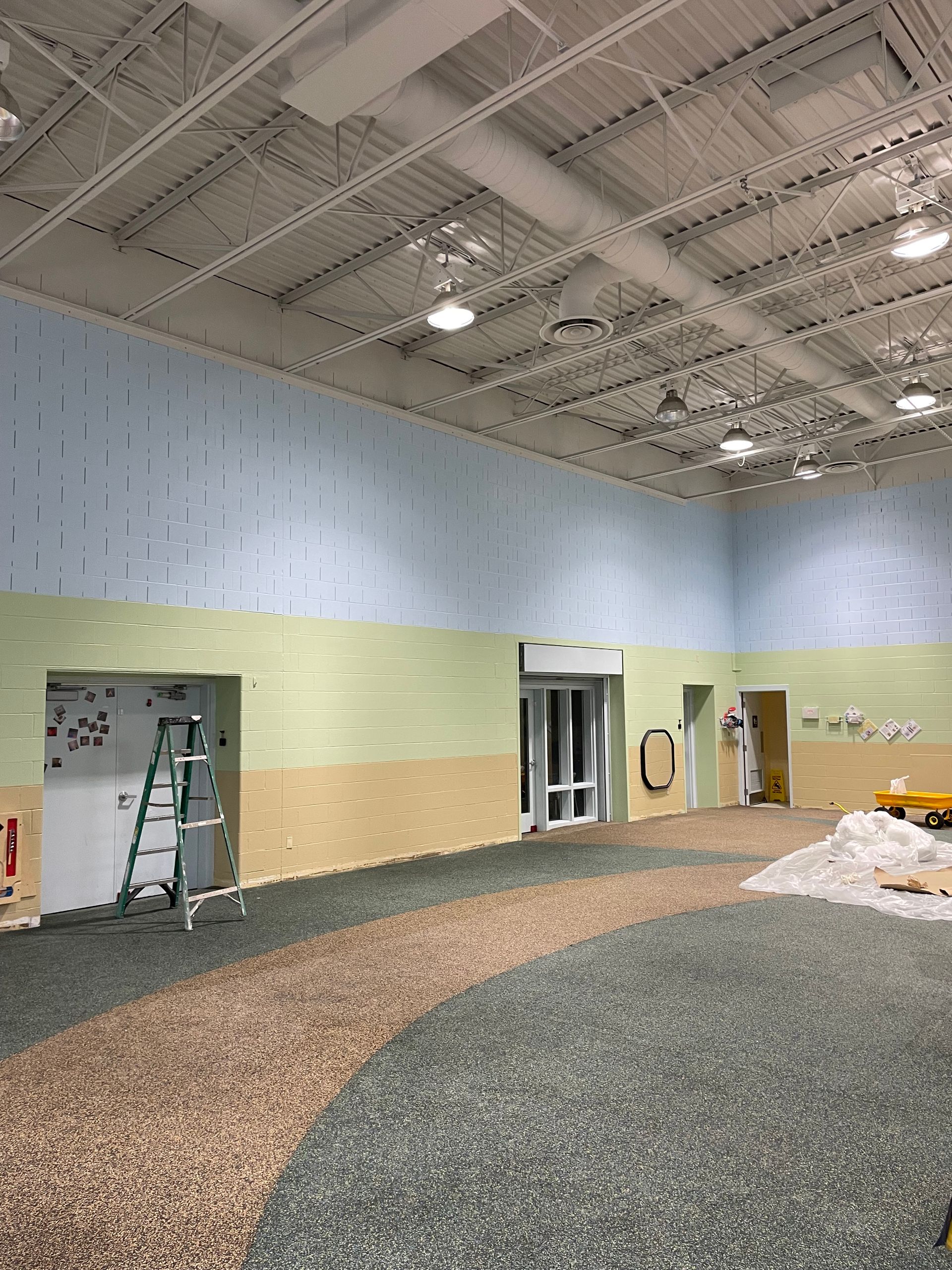 A large room with a ladder in the middle of it.