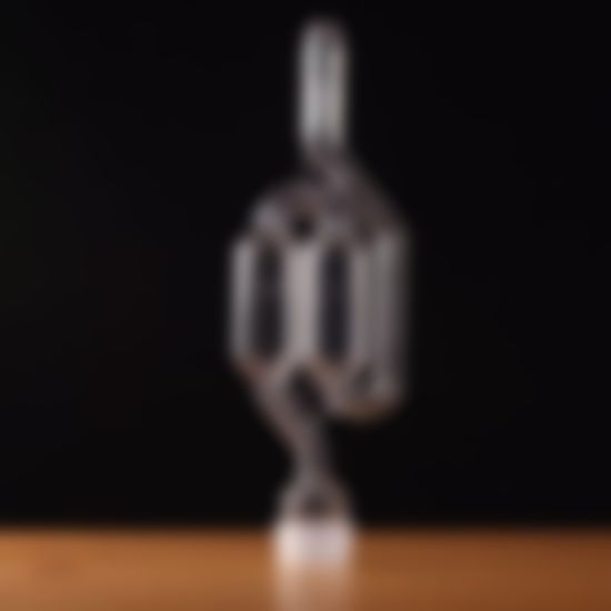 A clear glass object is sitting on a wooden table.