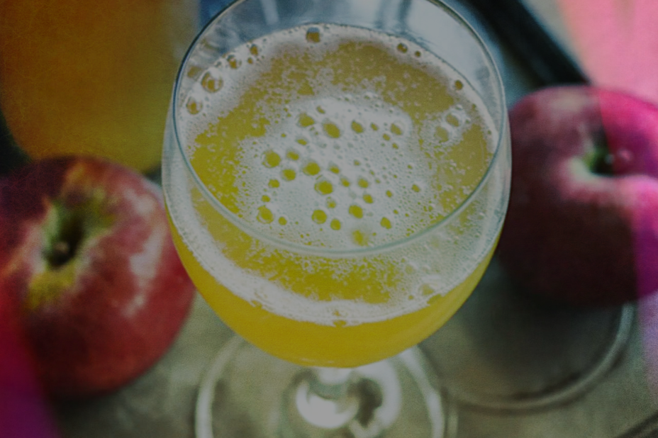 Glass of cider and two red apples