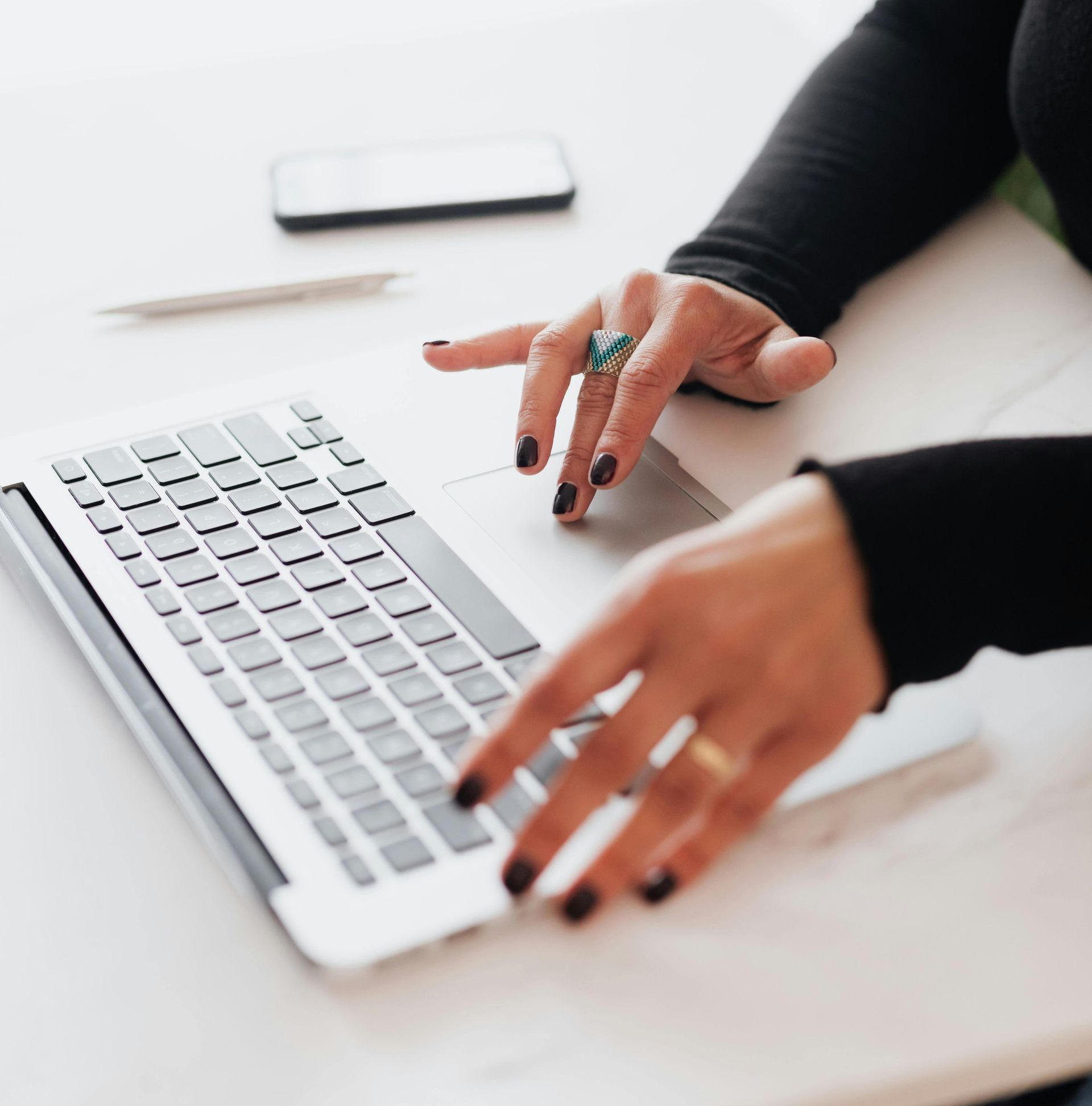 close-up of hands using a laptop doing SEO consultation to boost business success
