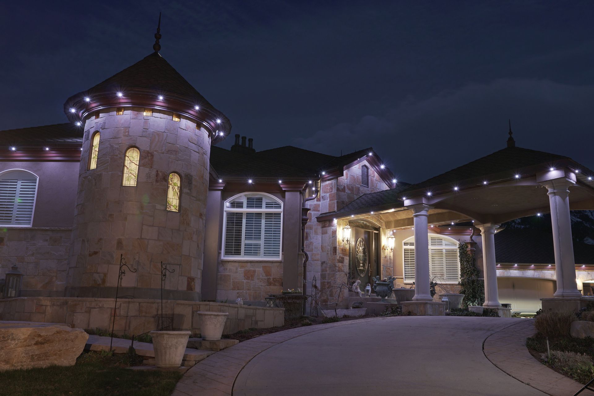 A large house is lit up at night with christmas lights
