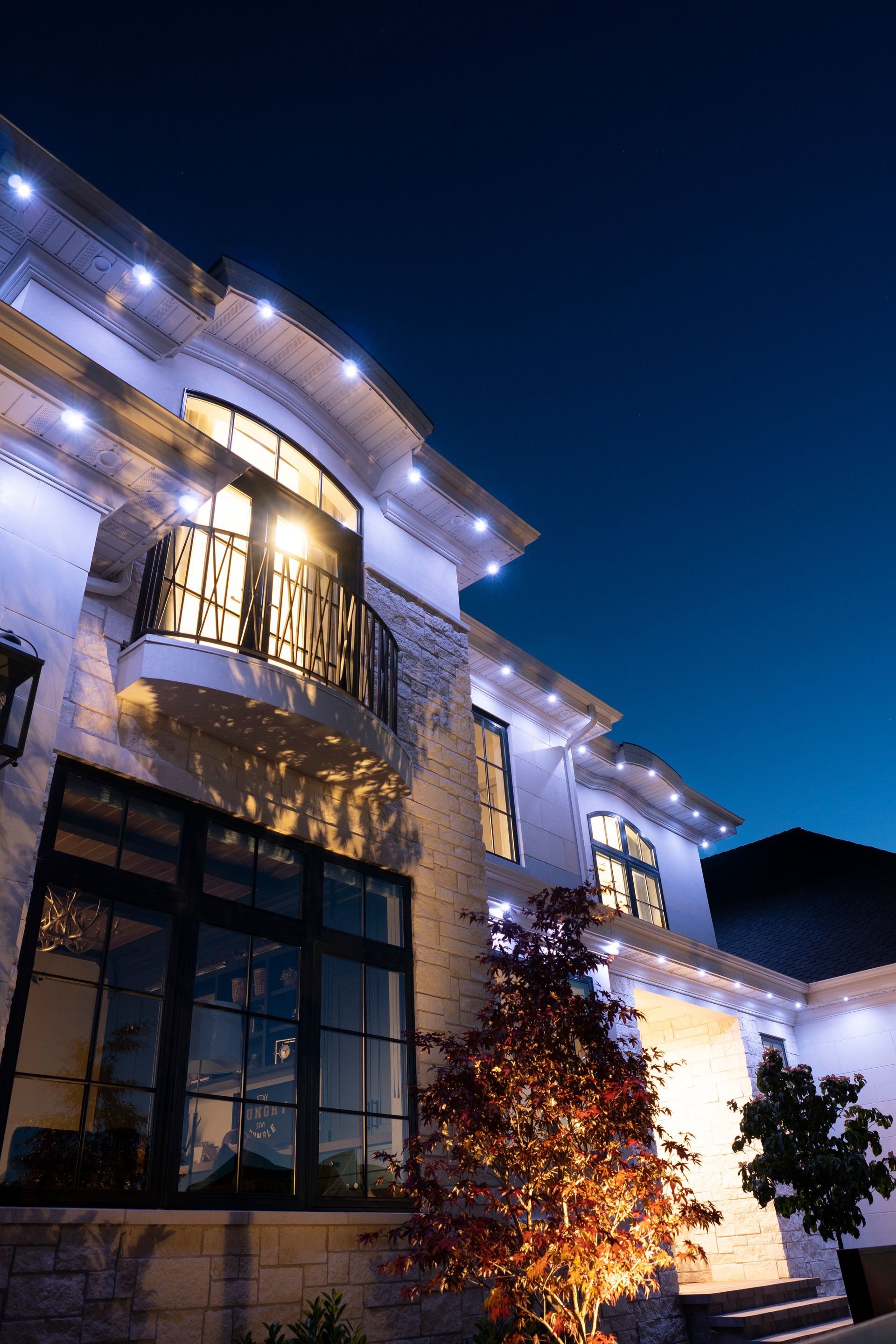 A house decorated for halloween with a skeleton and a bat