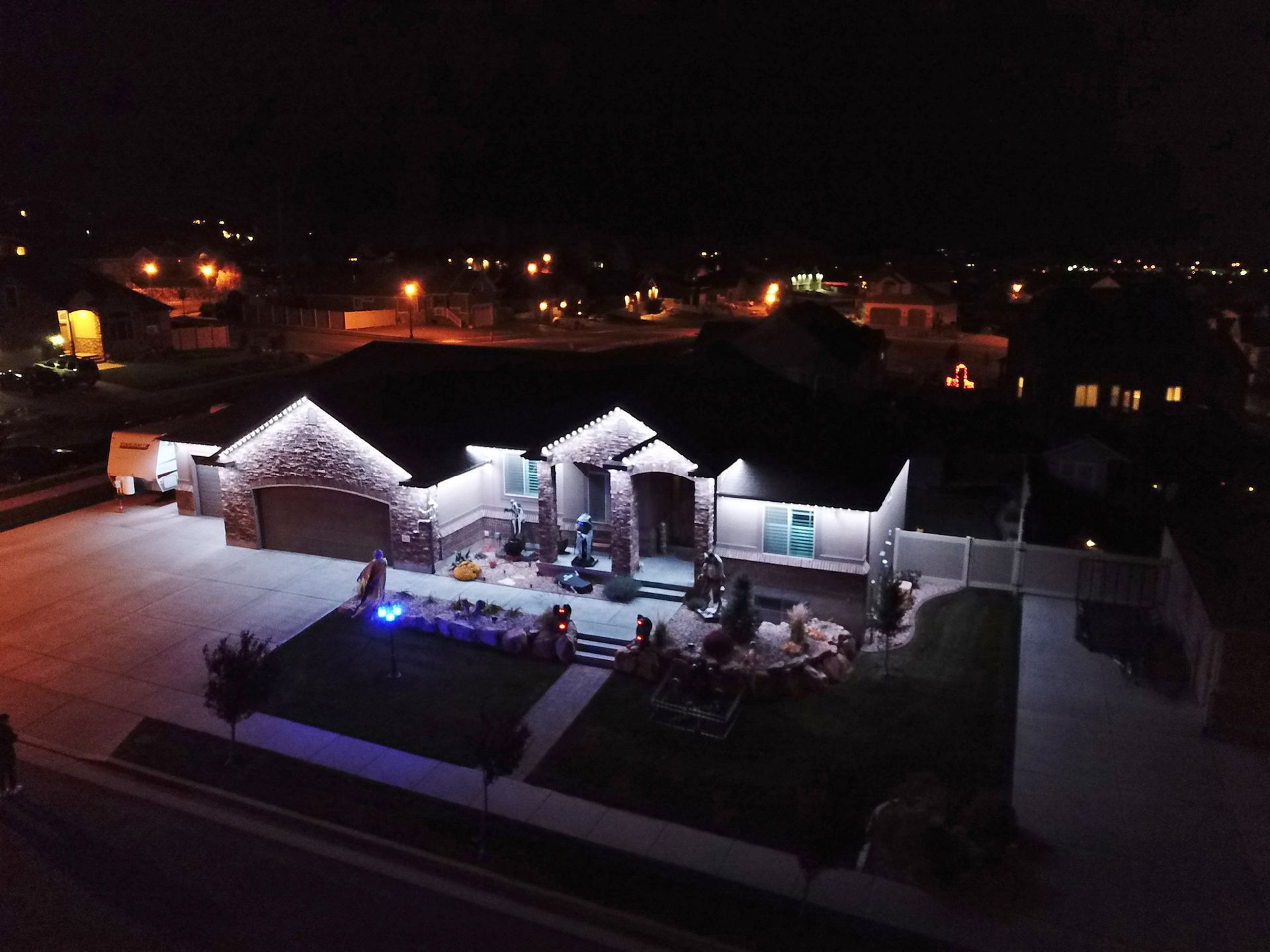 An aerial view of a house lit up at night.