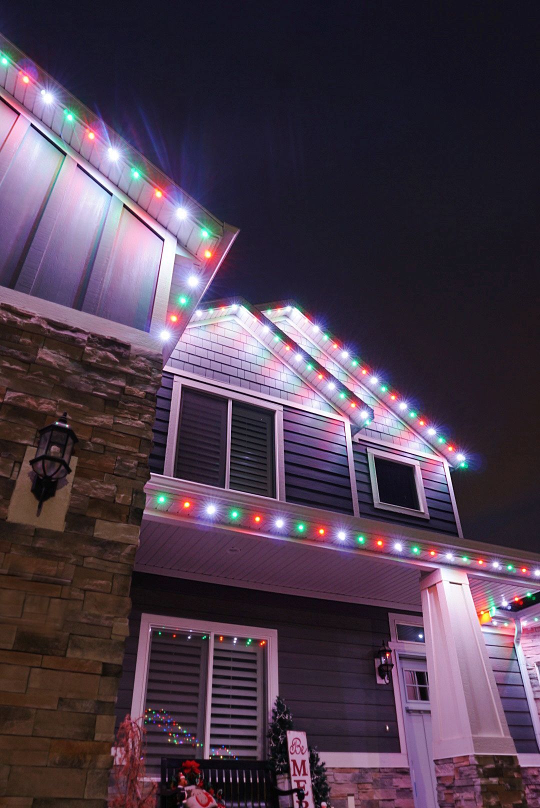 A house is decorated with christmas lights at night.