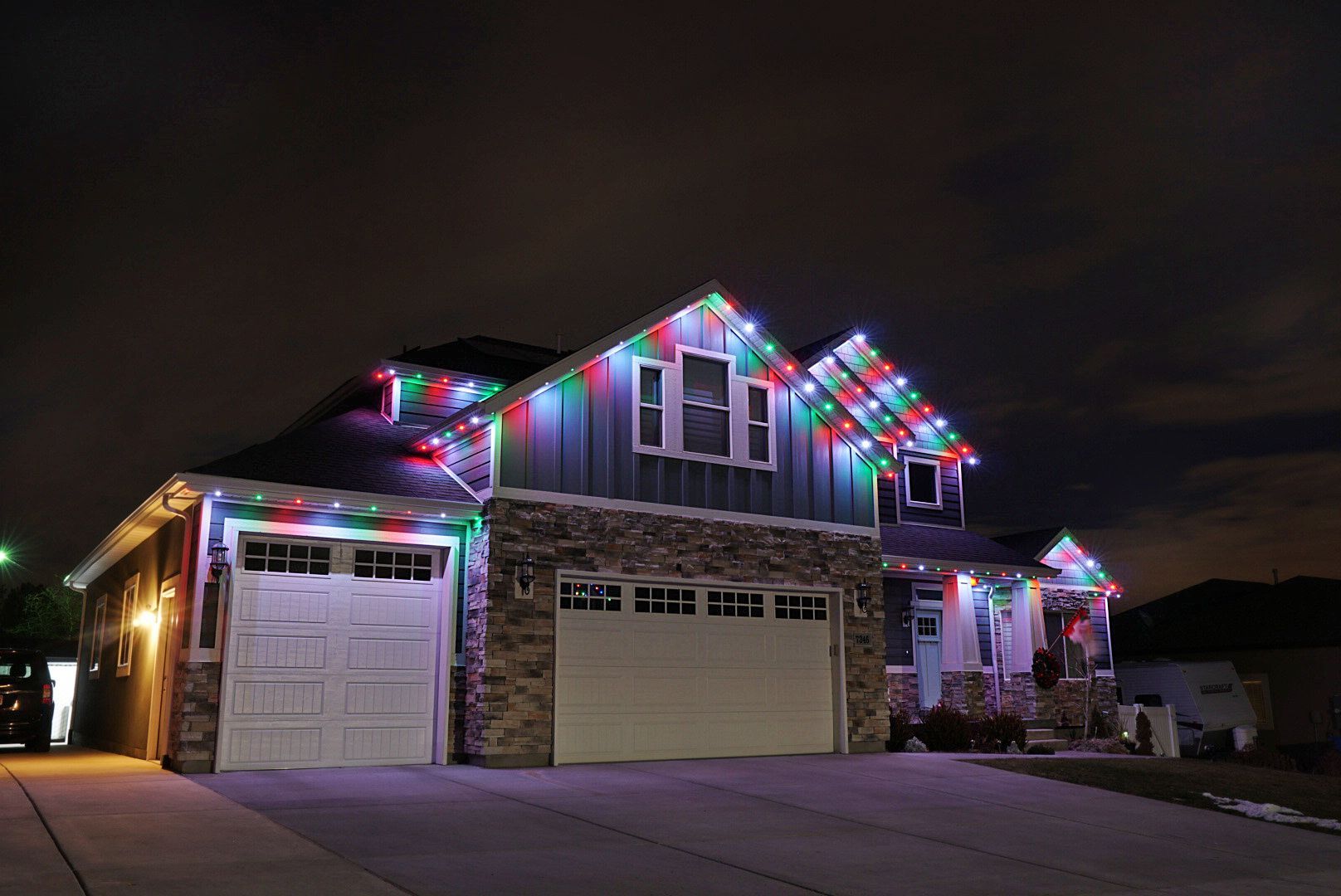 A house is decorated with christmas lights at night.