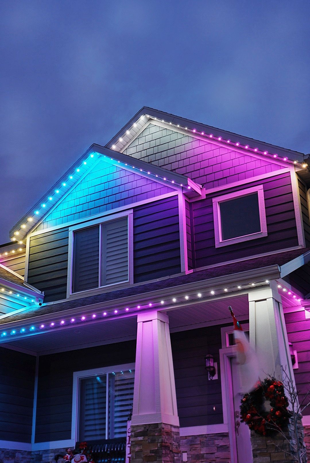 A house with christmas lights on it at night.
