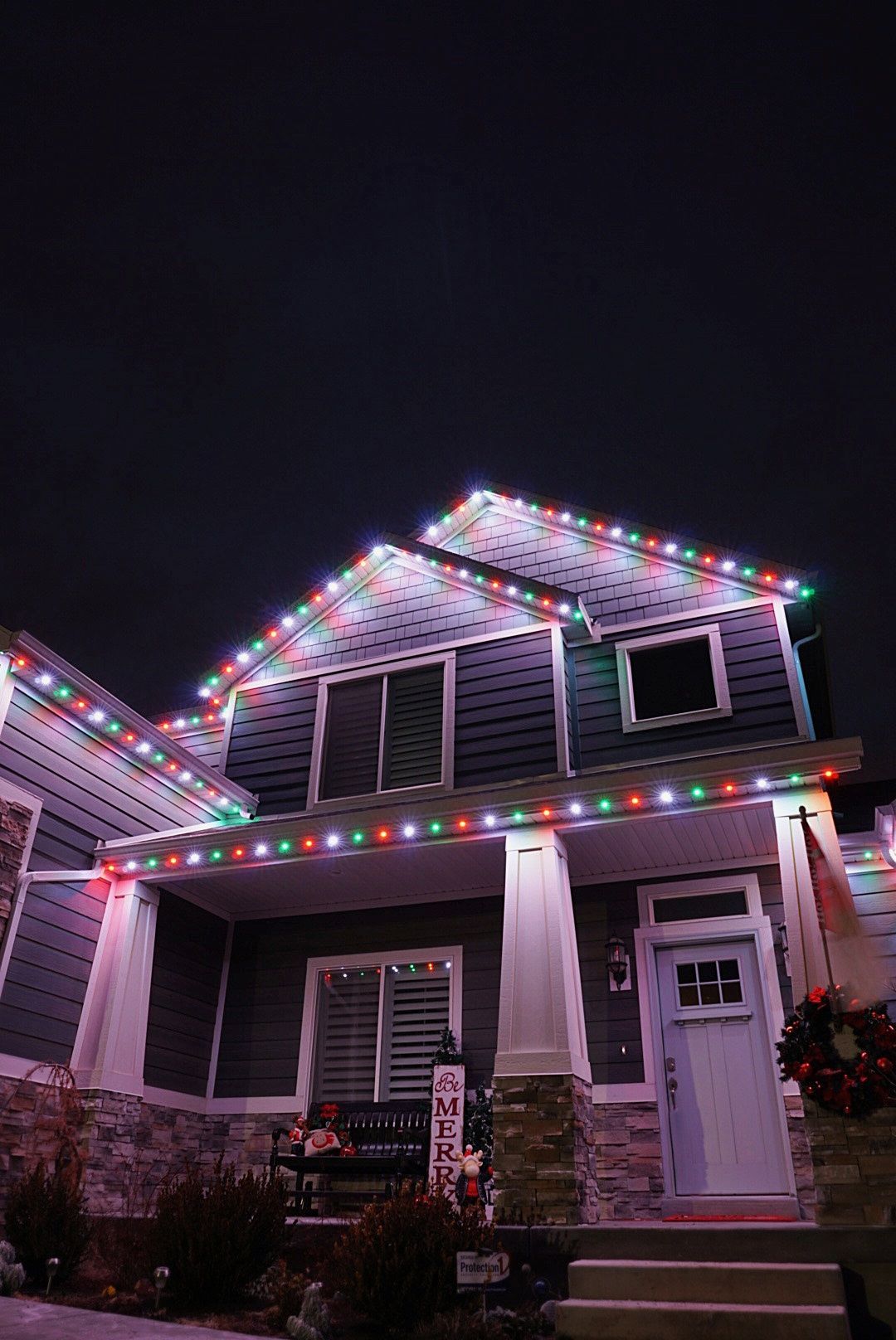 A house is decorated with christmas lights at night.