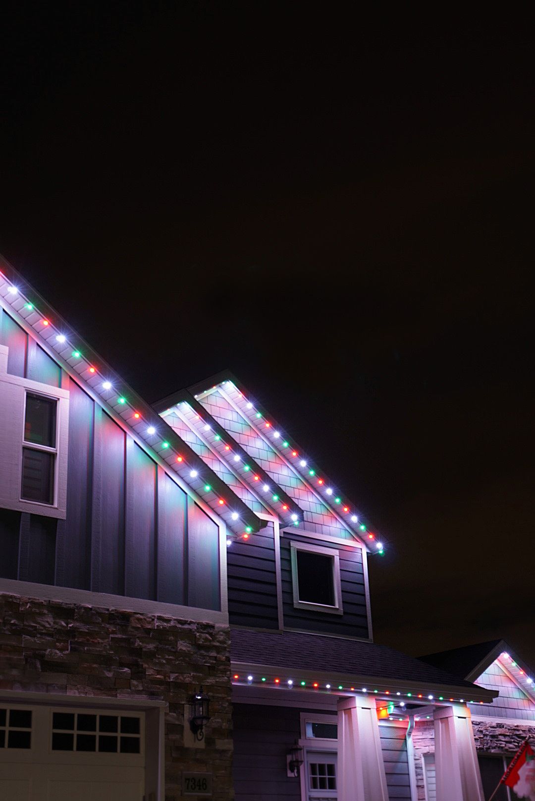 A house is decorated with christmas lights at night.