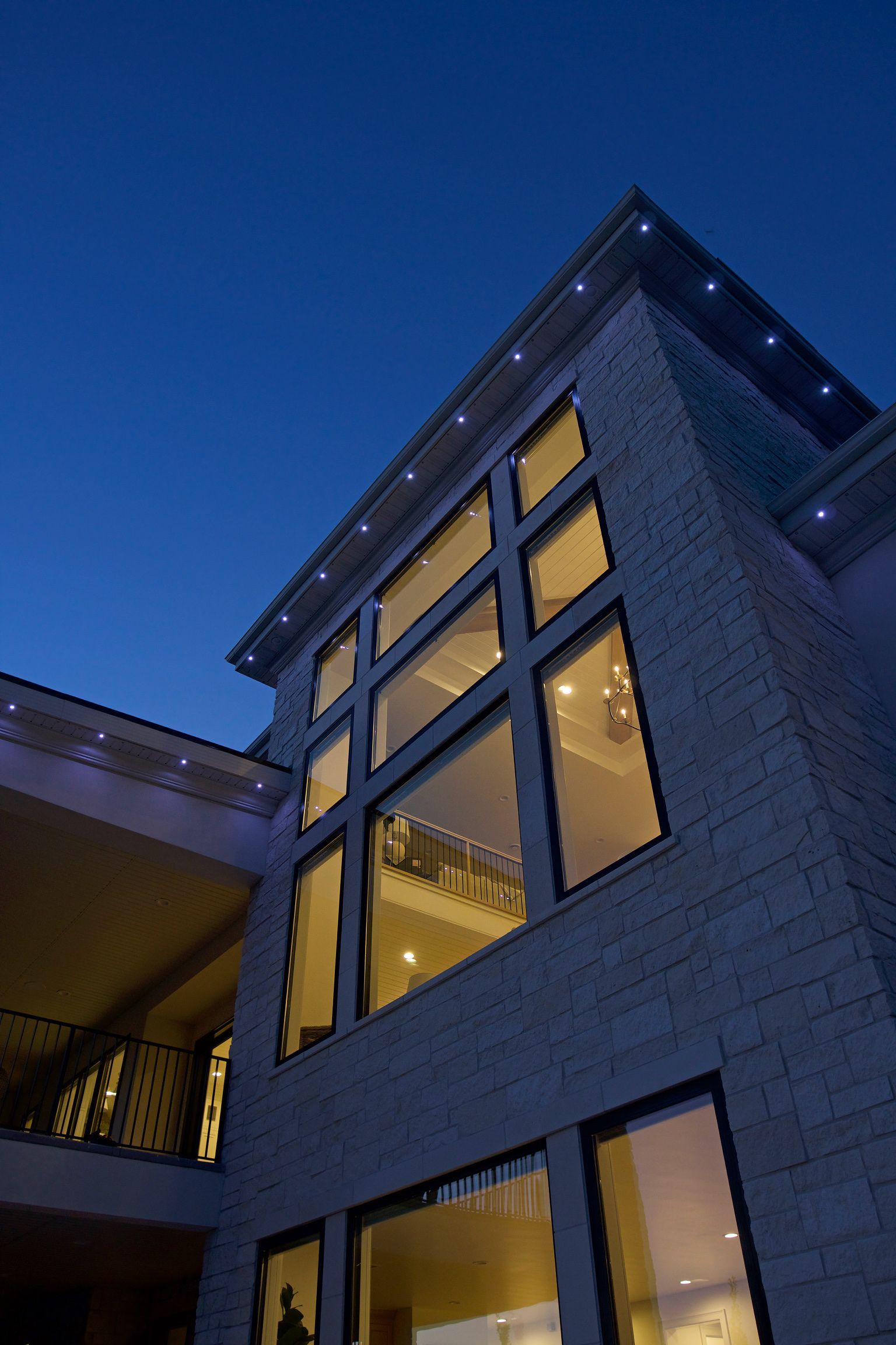 A large brick building with lots of windows at night