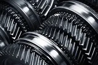 Close-up of interlocking metal gears, showing precision machinery and metallic textures.