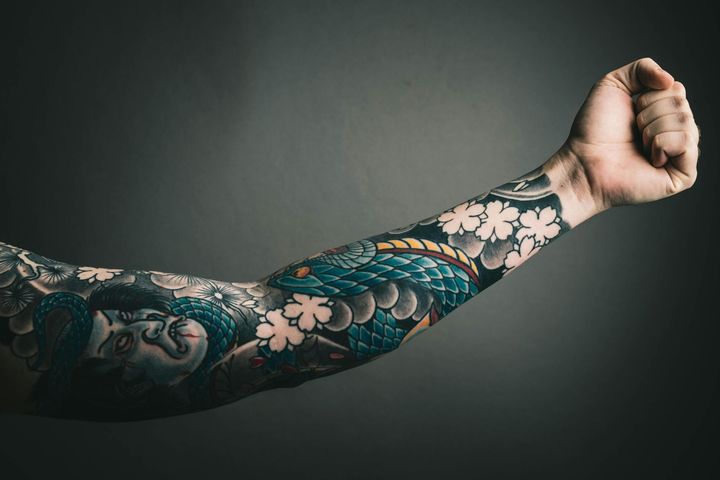 A close up of a person 's arm with a tattoo on it.