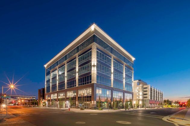 A large building with a lot of windows is lit up at night.