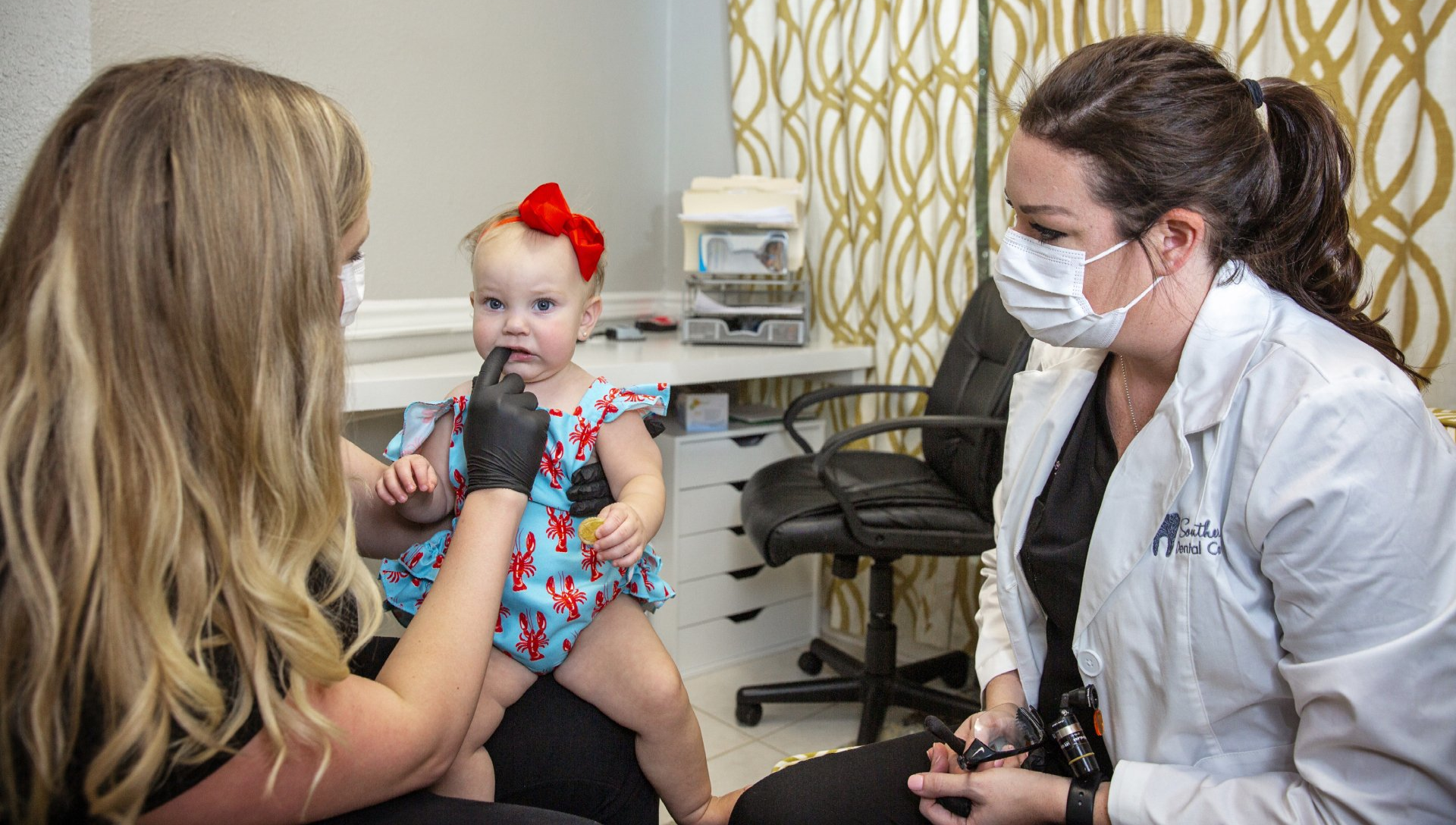 Dentist with child and mother | best pediatric dental training at Concord Family Dental in Hammond LA