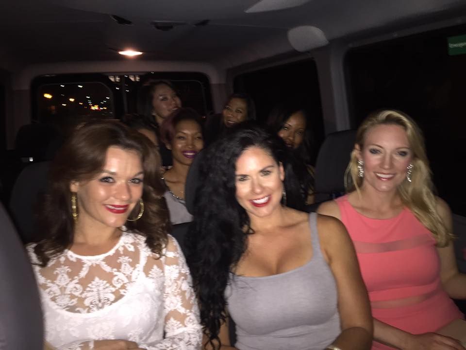 A group of women are sitting in the back of a van