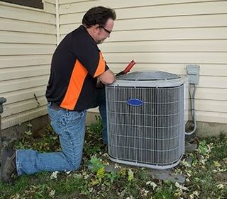 Repairman Checking Outside Air Conditioning Unit — plumbing in Westminster, CO