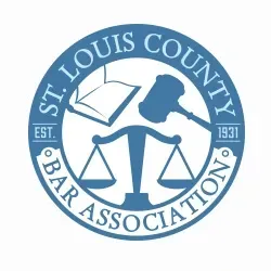 St. Louis County Bar Association blue circular logo with scales, gavel, and open book, est. 1931
