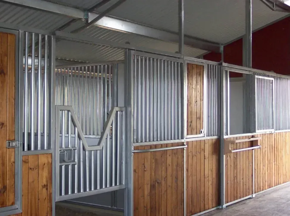 A horse stable with wooden walls and metal fences