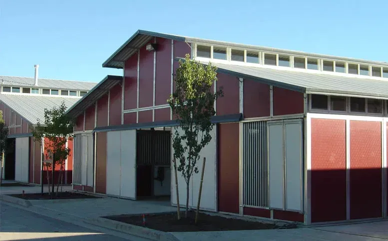 A red and white building with a tree in front of it