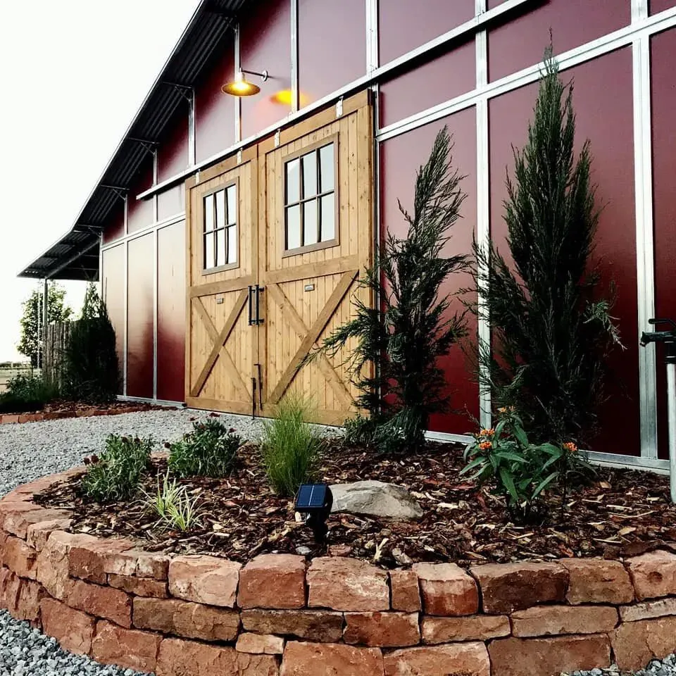 A red barn with a wooden sliding barn door