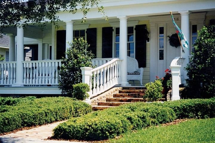 A white house with a porch and stairs