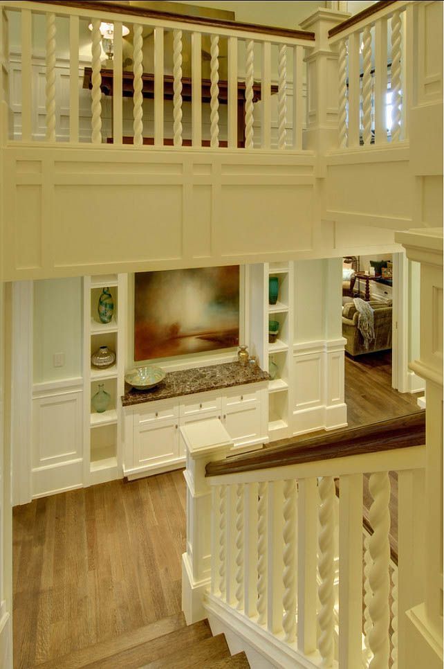 A staircase with a railing and a picture on the wall